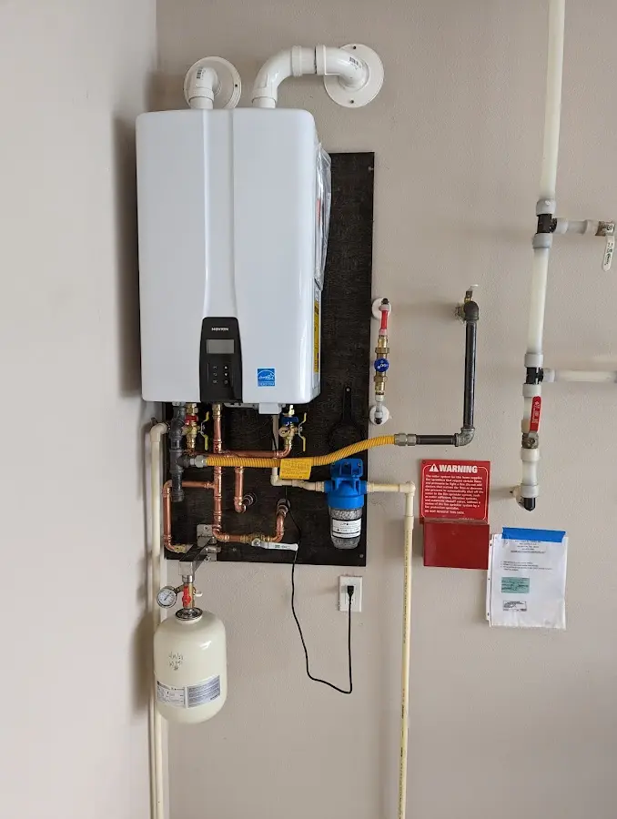 Professional plumber installing copper piping in a Riverside home